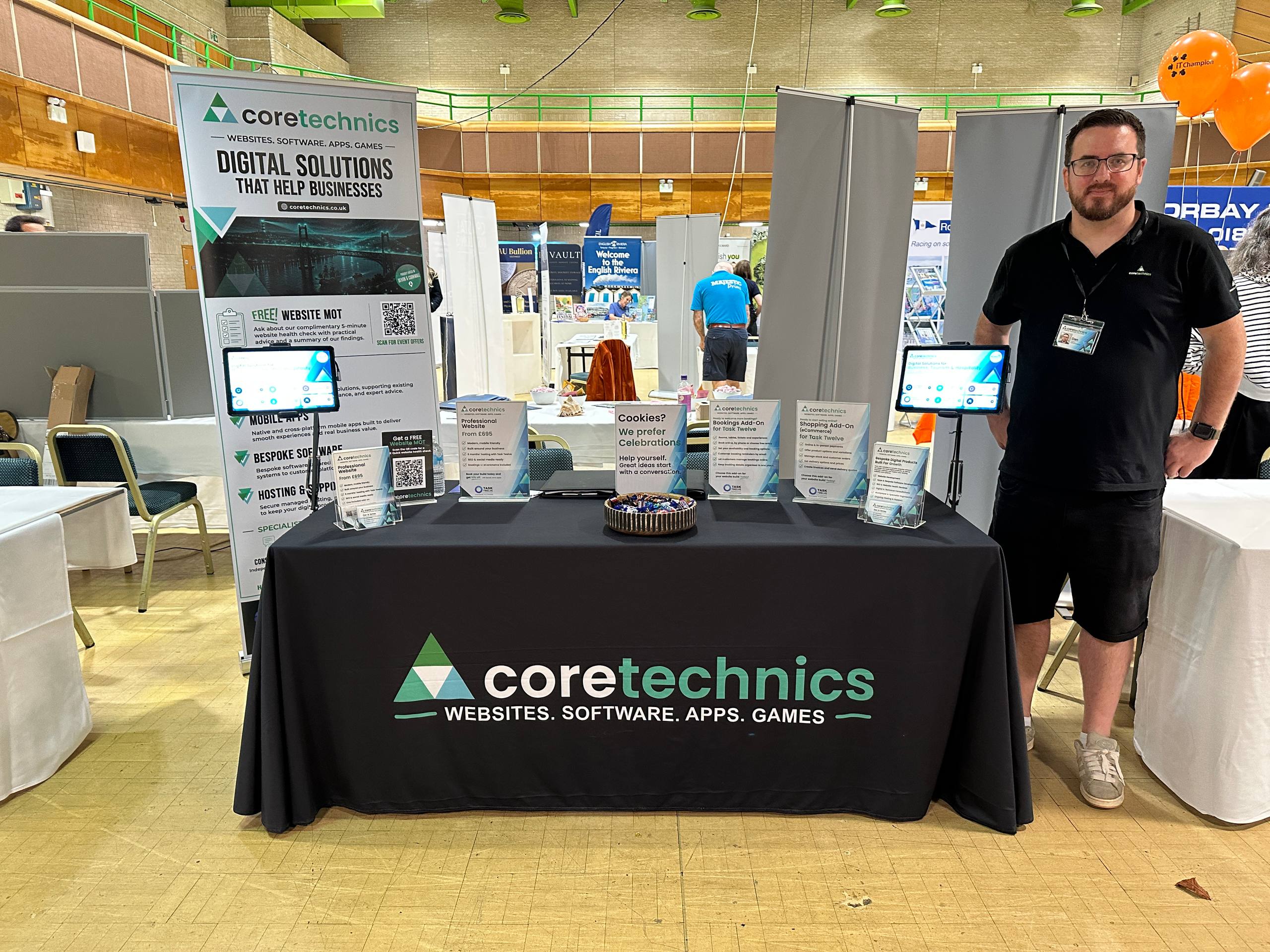 CoreTechnics team member beside the branded stand at Riviera Connect EXPO